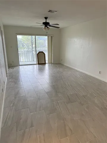 a view of a livingroom with a fireplace and window