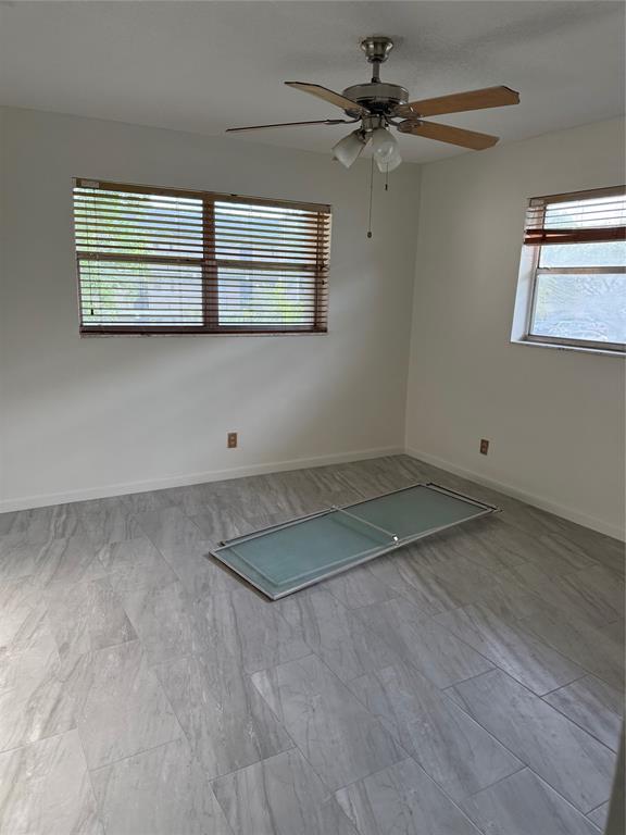 7901 North Colony Circle, Unit 201 Fort Lauderdale, FL 33321 - Photo 4 of 9 a view of a room with wooden floor and fan