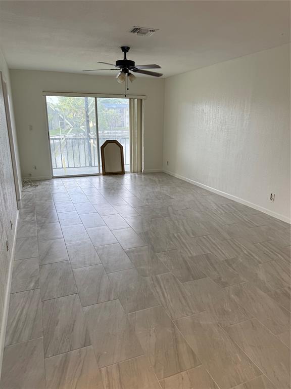 7901 North Colony Circle, Unit 201 Fort Lauderdale, FL 33321 - Photo 6 of 9 a view of a livingroom with a fireplace and window
