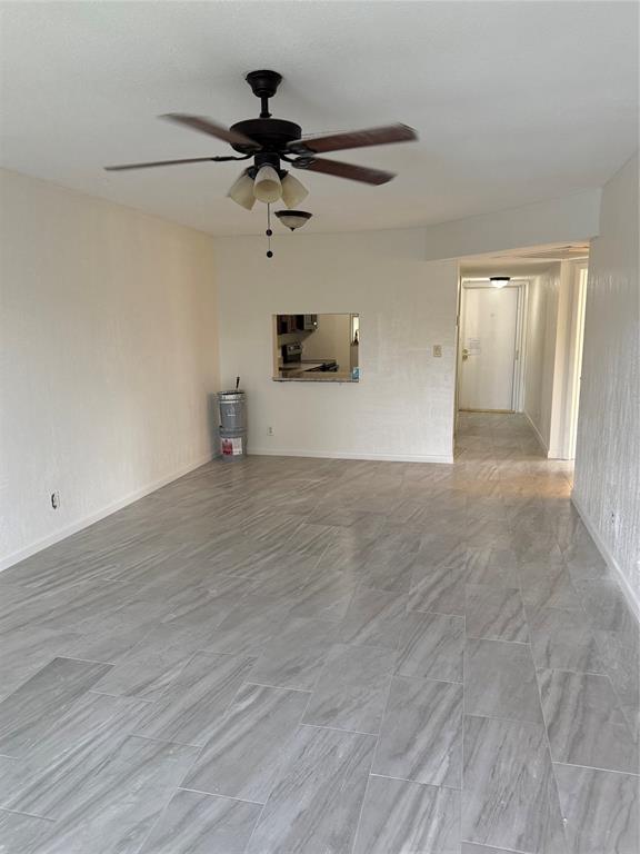 7901 North Colony Circle, Unit 201 Fort Lauderdale, FL 33321 - Photo 7 of 9 a view of a livingroom with a ceiling fan and hardwood floor