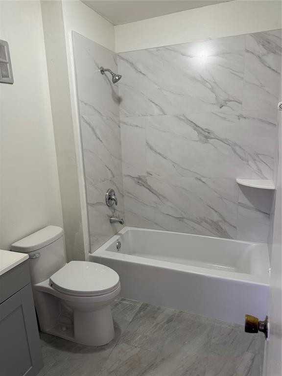 7901 North Colony Circle, Unit 201 Fort Lauderdale, FL 33321 - Photo 9 of 9 a white toilet and tub sitting next to a bathroom sink