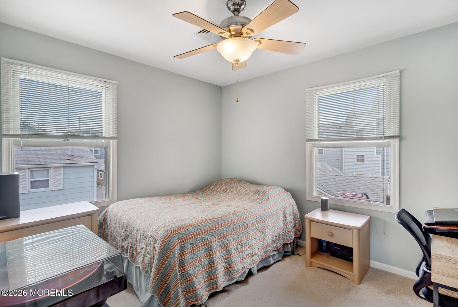 19 Shore Way Lavallette, NJ 08735 - Photo 17 of 38 a bedroom with a bed and a chandelier