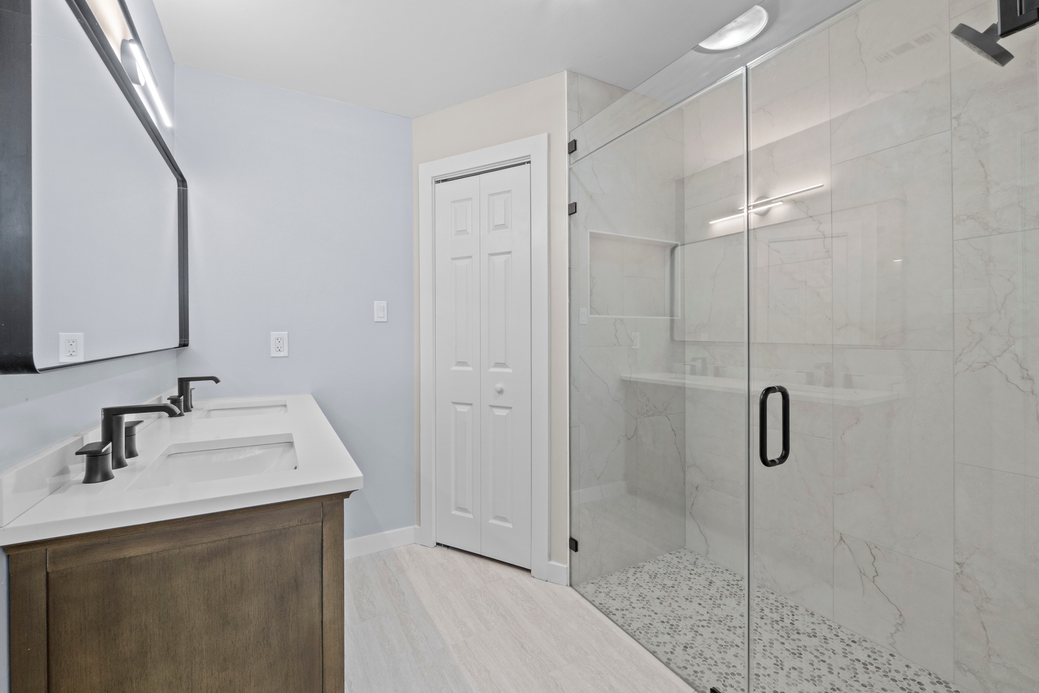 11811 Rotherham Drive Austin, TX 78754 - Photo 20 of 37 A well-appointed bathroom offers dual vanities and a spacious glass-enclosed shower.
