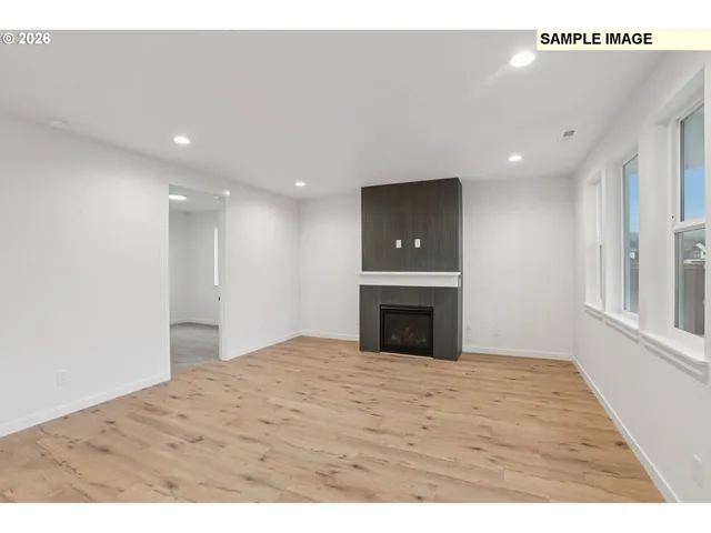 a view of empty room with a fireplace