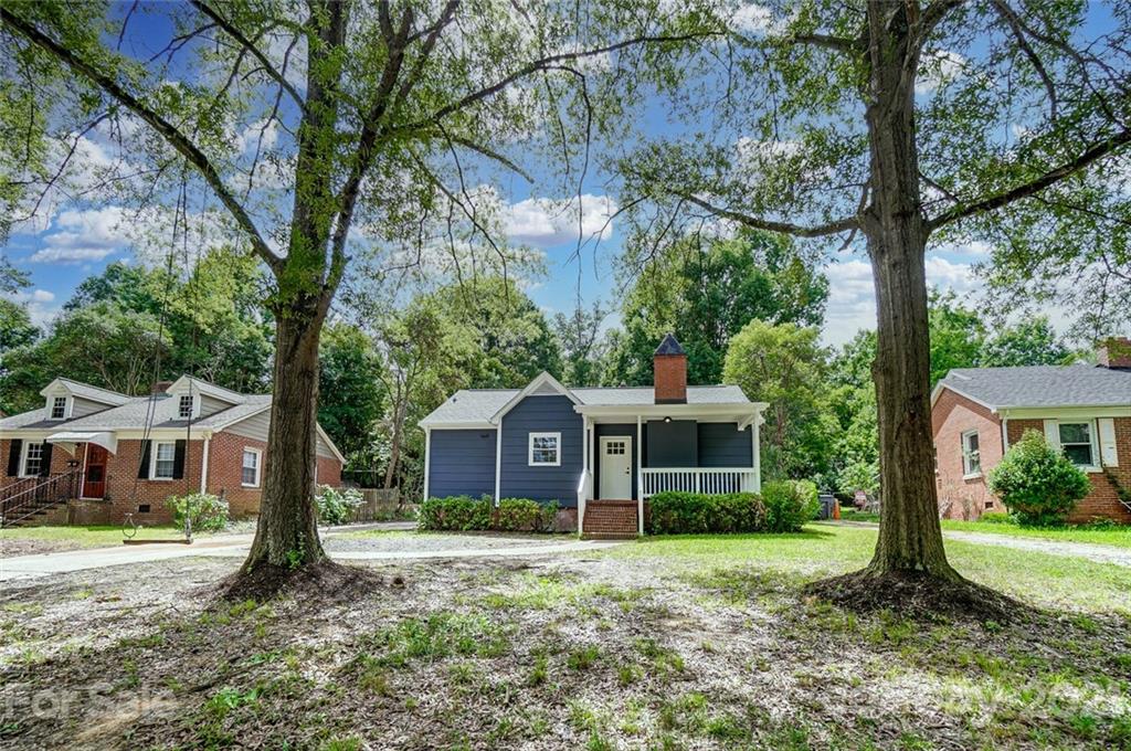 a front view of a house with yard and green space