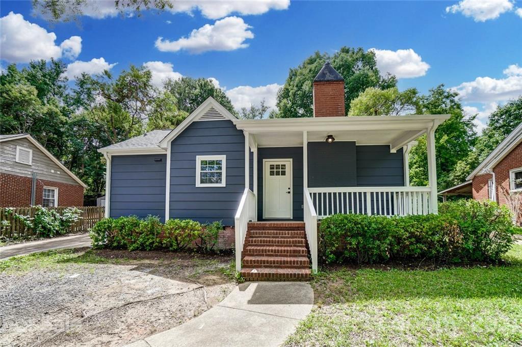 2305 Remount Road Charlotte, NC 28208 - Photo 2 of 31 a view of a brick house with a yard plants and large tree