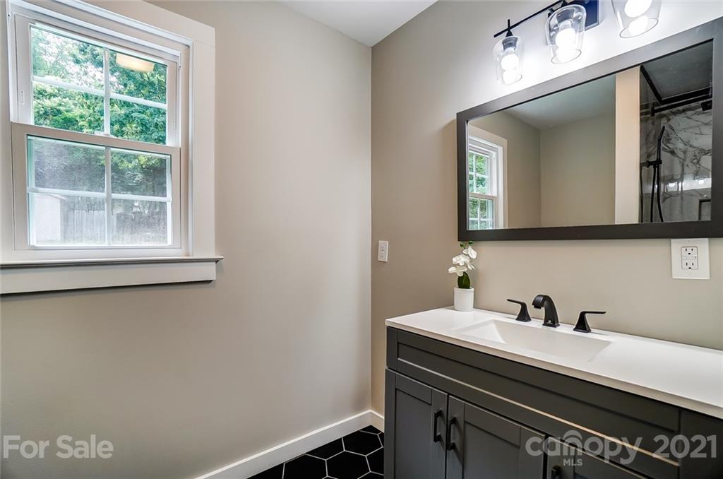 2305 Remount Road Charlotte, NC 28208 - Photo 17 of 31 a bathroom with a sink a vanity and a mirror
