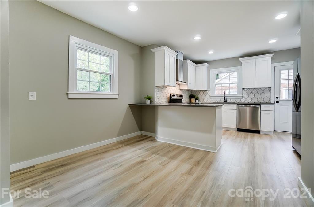 2305 Remount Road Charlotte, NC 28208 - Photo 19 of 31 a kitchen with stainless steel appliances granite countertop a sink a stove a refrigerator and cabinets