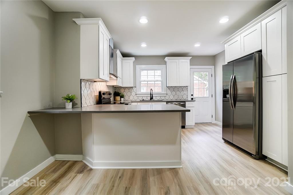 2305 Remount Road Charlotte, NC 28208 - Photo 20 of 31 a kitchen with stainless steel appliances granite countertop a refrigerator sink and cabinets