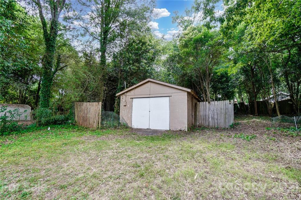 2305 Remount Road Charlotte, NC 28208 - Photo 22 of 31 a view of a tiny house with a yard and large trees