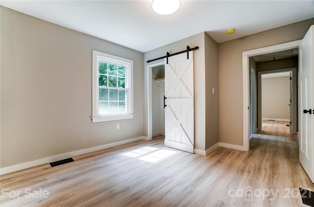 2305 Remount Road Charlotte, NC 28208 - Photo 24 of 31 a view of an empty room with wooden floor and a window