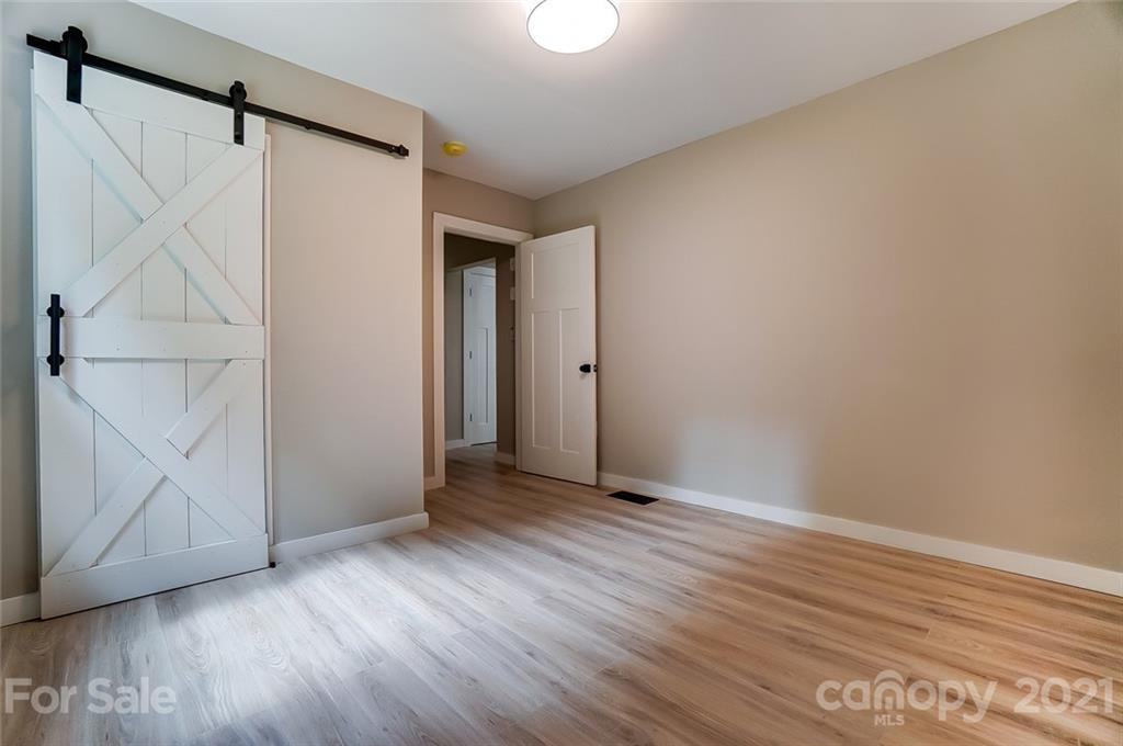 2305 Remount Road Charlotte, NC 28208 - Photo 25 of 31 a view of an empty room with wooden floor and a window