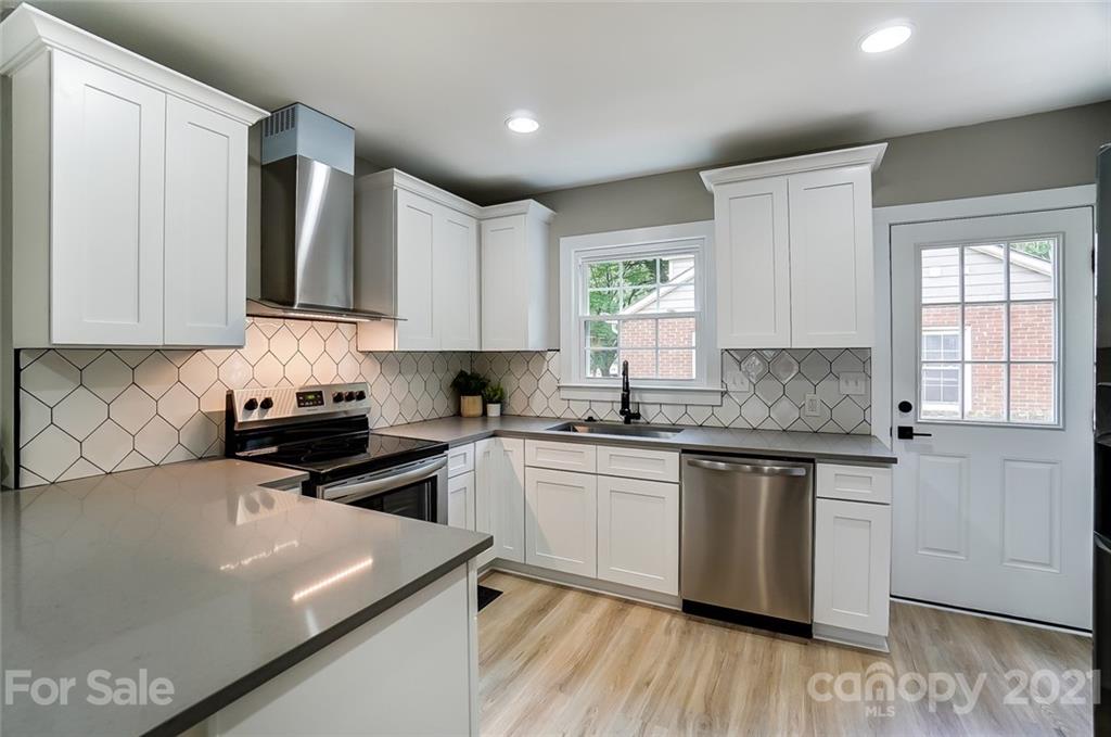 2305 Remount Road Charlotte, NC 28208 - Photo 4 of 31 a kitchen with stainless steel appliances white cabinets a sink and a stove