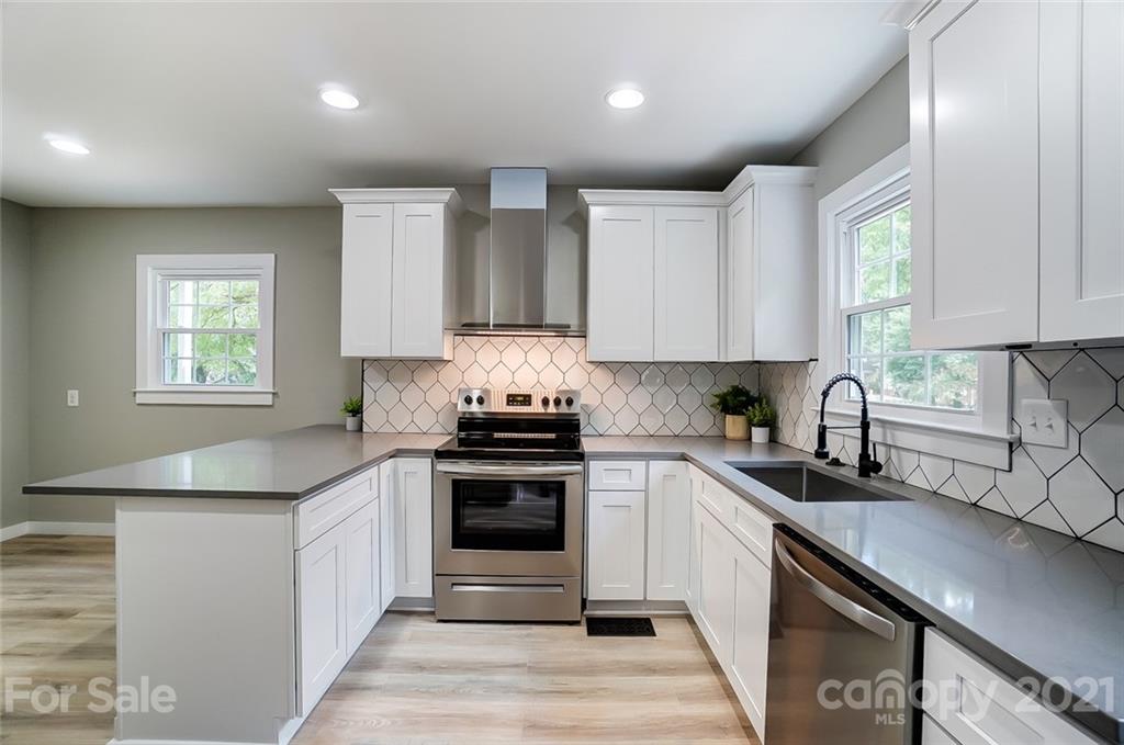 2305 Remount Road Charlotte, NC 28208 - Photo 5 of 31 a kitchen with stainless steel appliances granite countertop a sink stove and cabinets