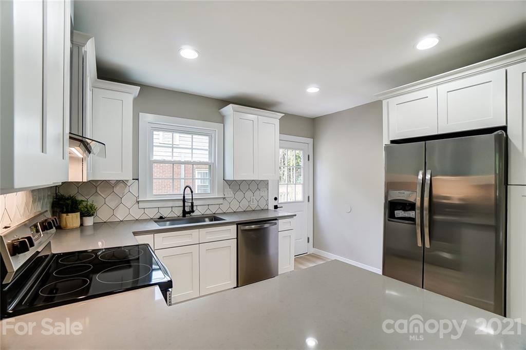 2305 Remount Road Charlotte, NC 28208 - Photo 6 of 31 a kitchen with a sink a refrigerator and cabinets