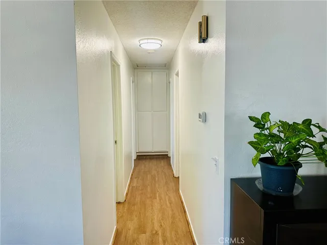 a view of a hallway with wooden floor