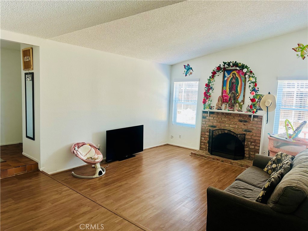 2111 Whitestone Drive Riverside, CA 92506 - Photo 15 of 29 a living room with furniture fireplace and painting on the wall