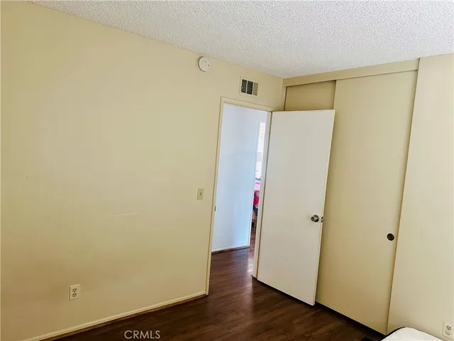 a view of closet area with wooden floor