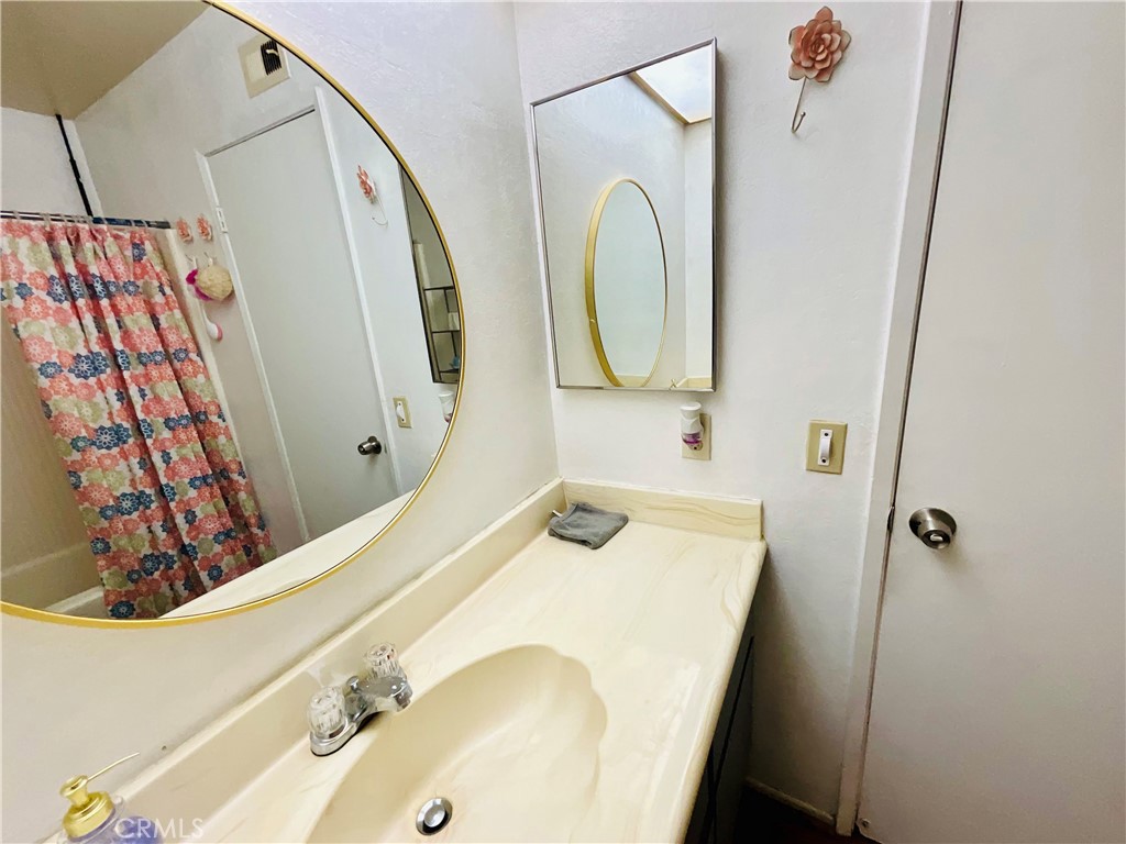 2111 Whitestone Drive Riverside, CA 92506 - Photo 22 of 29 a bathroom with a sink and mirror with bathtub
