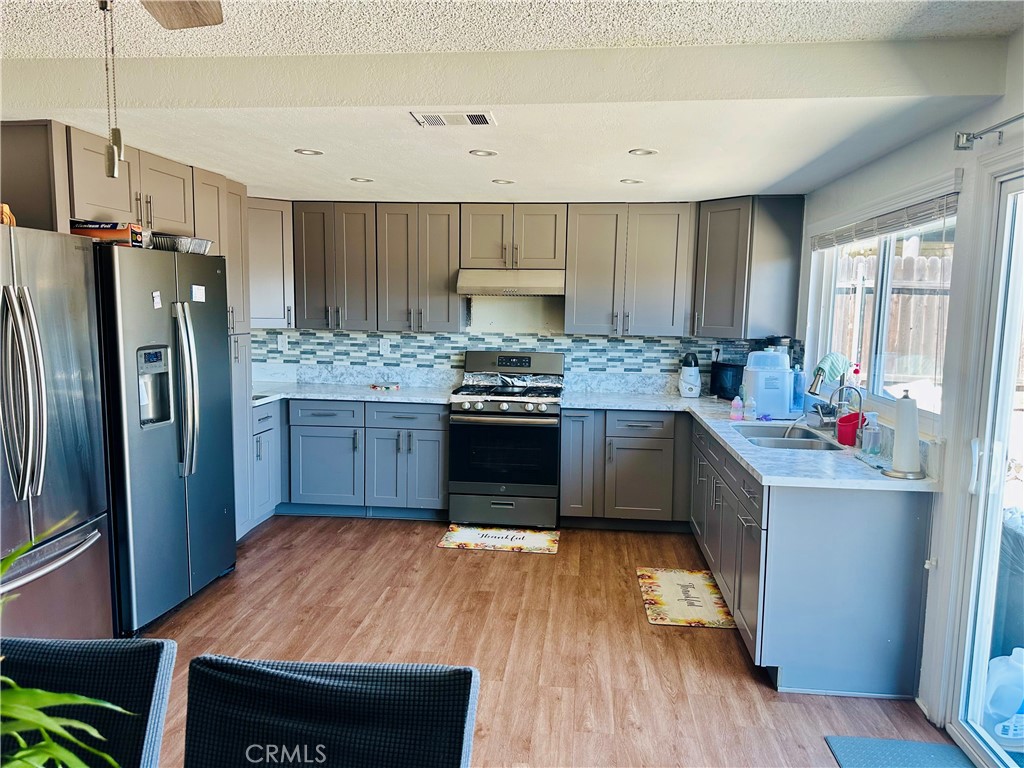 2111 Whitestone Drive Riverside, CA 92506 - Photo 9 of 29 a kitchen with stainless steel appliances granite countertop a stove a refrigerator and a refrigerator