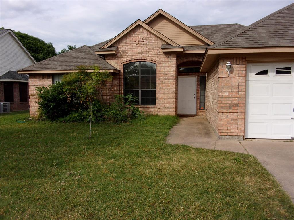 1511 Spanish Oak Drive Granbury, TX 76048 - Photo 1 of 16 a front view of a house with garden