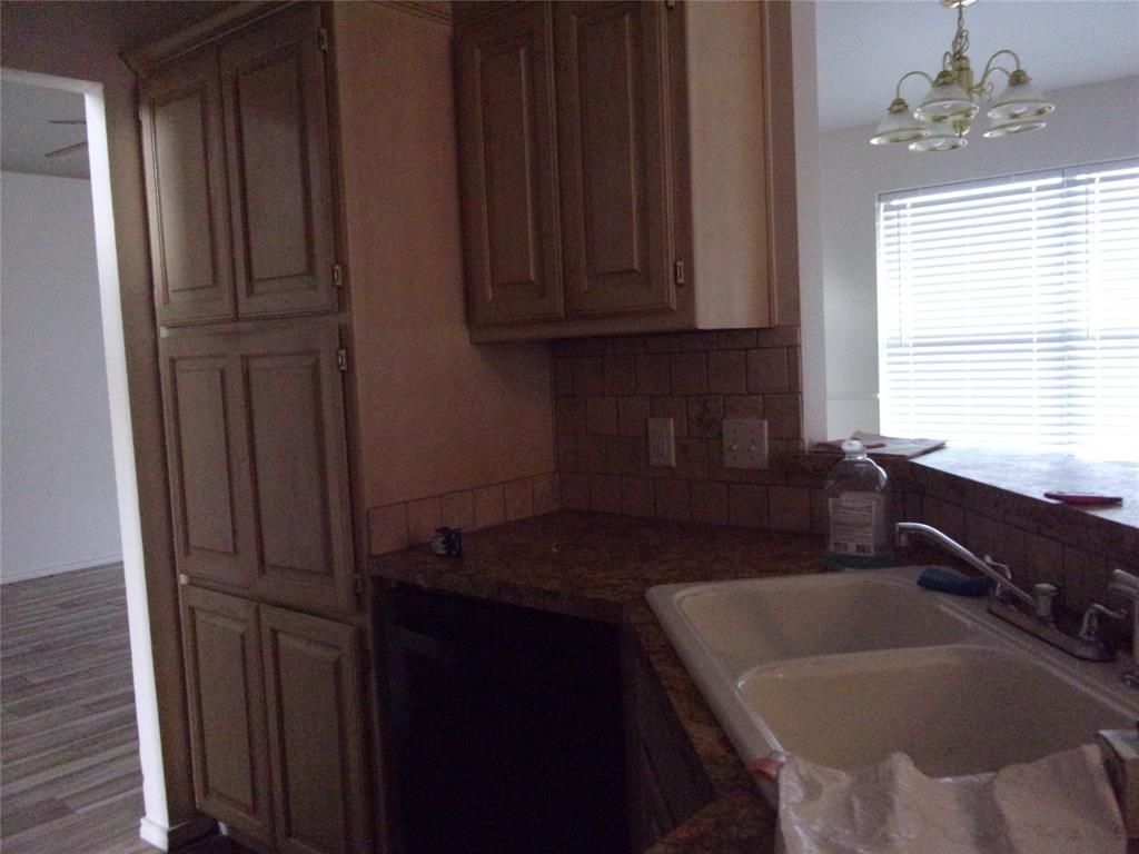 1511 Spanish Oak Drive Granbury, TX 76048 - Photo 14 of 16 a kitchen with a sink and cabinets