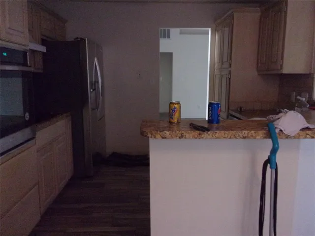 a kitchen with a refrigerator and a sink