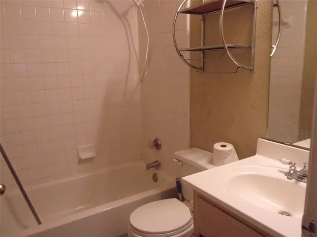 a bathroom with a toilet sink and shower