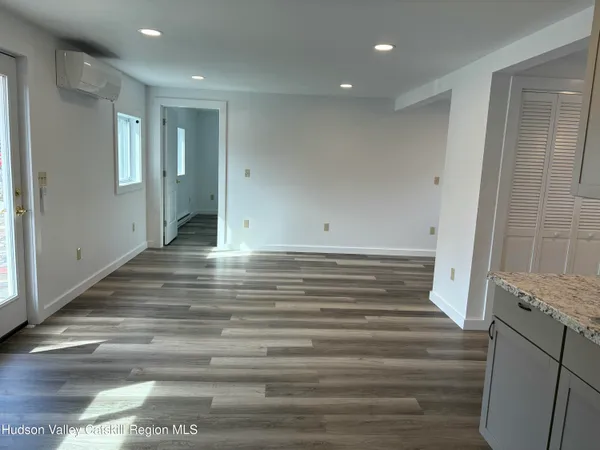 a view of room with cabinets and wooden floor