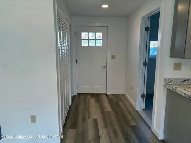 a view of hallway with wooden floor