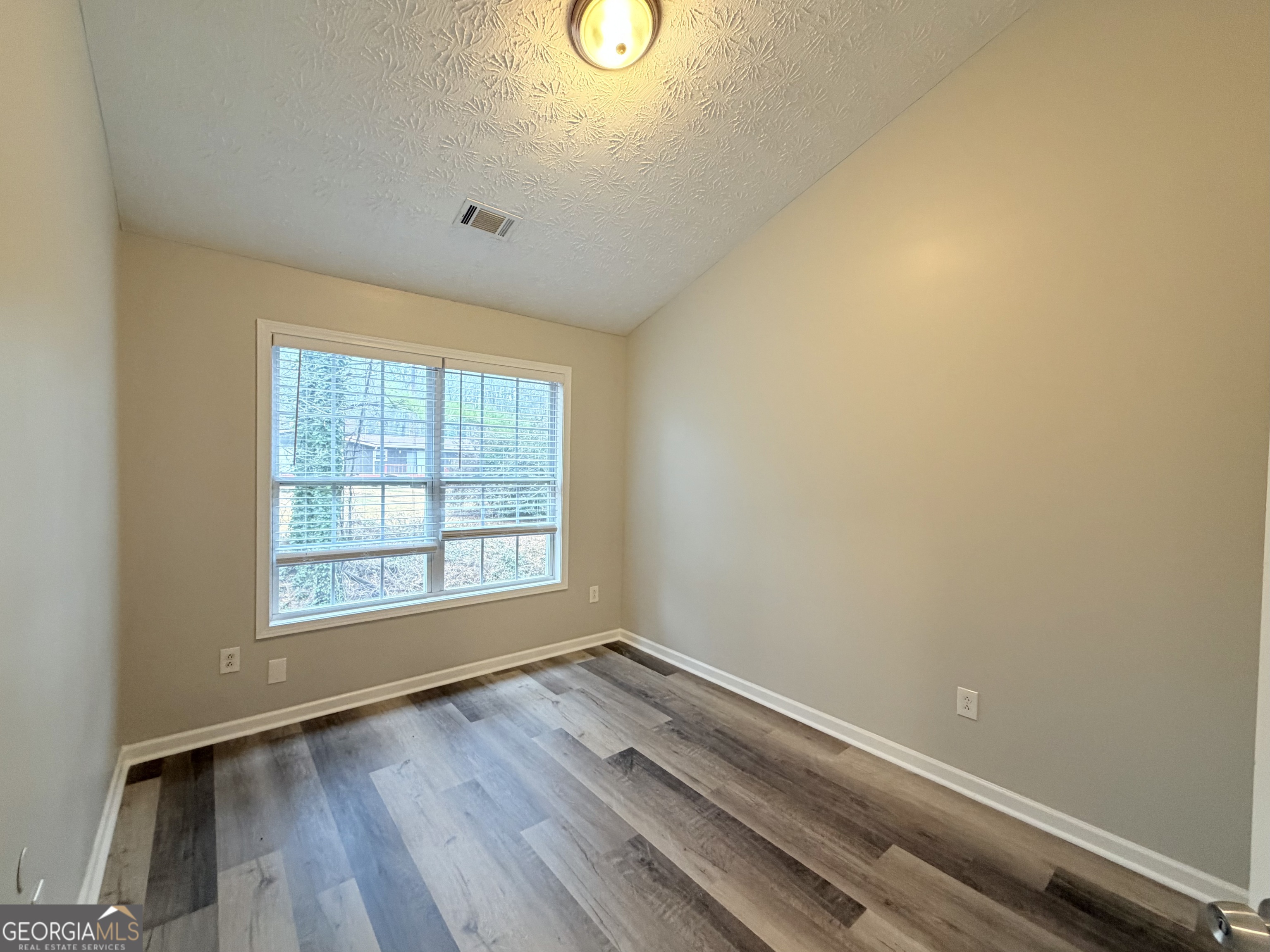 20 Pine Canyon Drive Southwest, Unit 4 Atlanta, GA 30331 - Photo 15 of 21 an empty room with wooden floor and windows