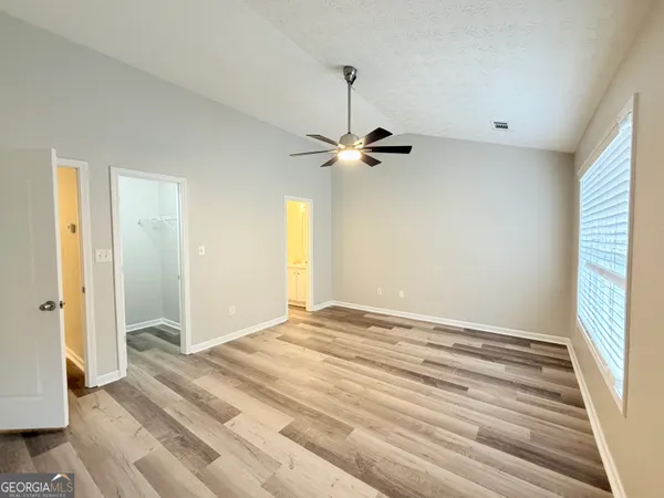 a view of a room with a ceiling fan