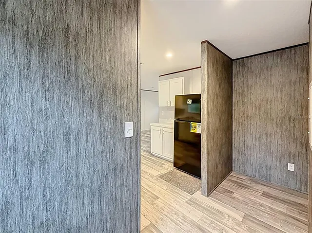 a view of a hallway with wooden shelves