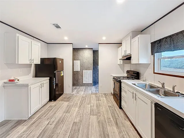 a kitchen with stainless steel appliances a refrigerator stove microwave and sink