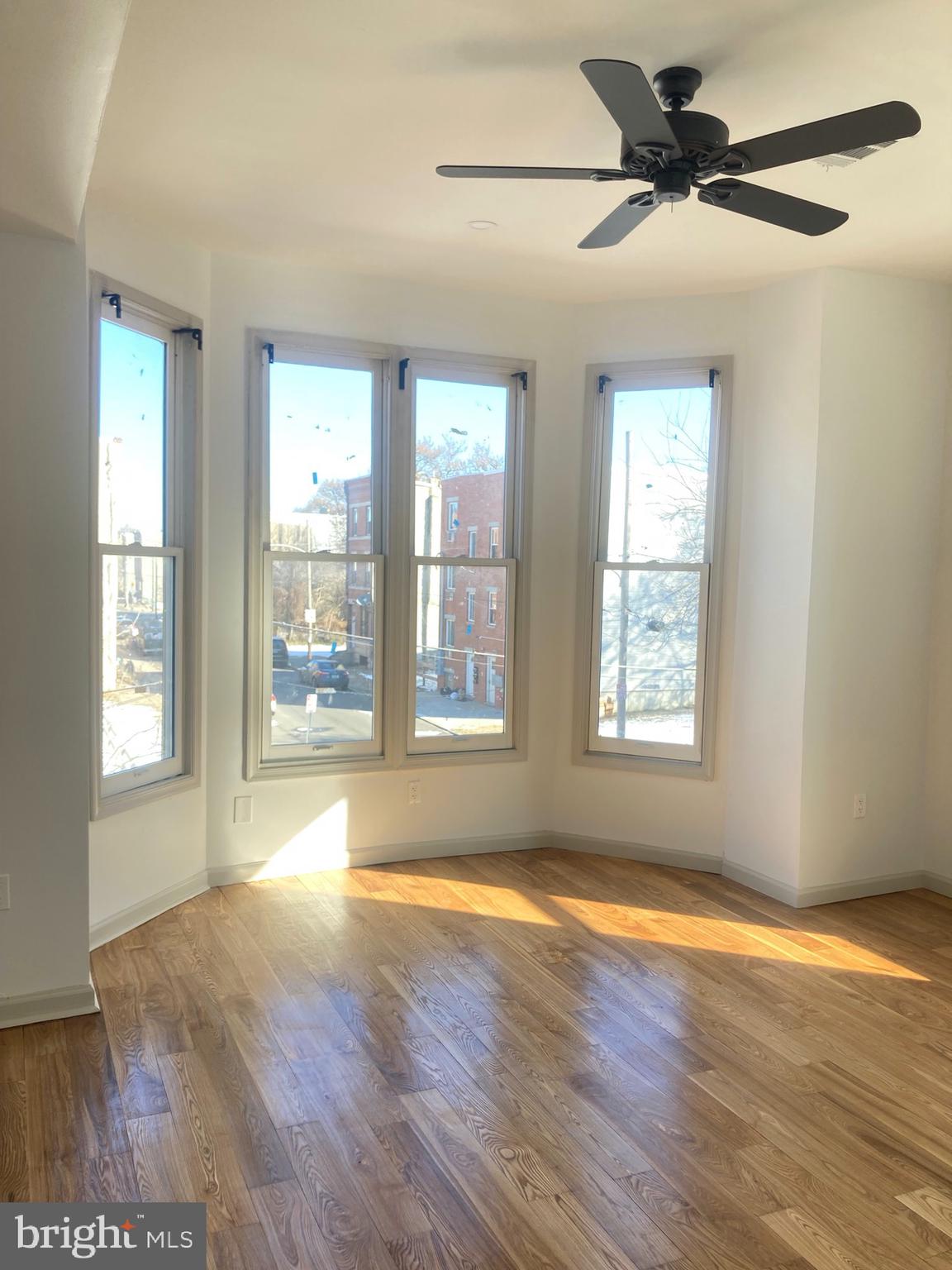1901 West Diamond Street, Unit 2 Philadelphia, PA 19121 - Photo 9 of 9 a view of an empty room with wooden floor and a window
