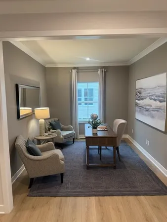a living room with furniture rug and window