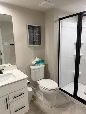 a white toilet sitting next to a bathroom sink