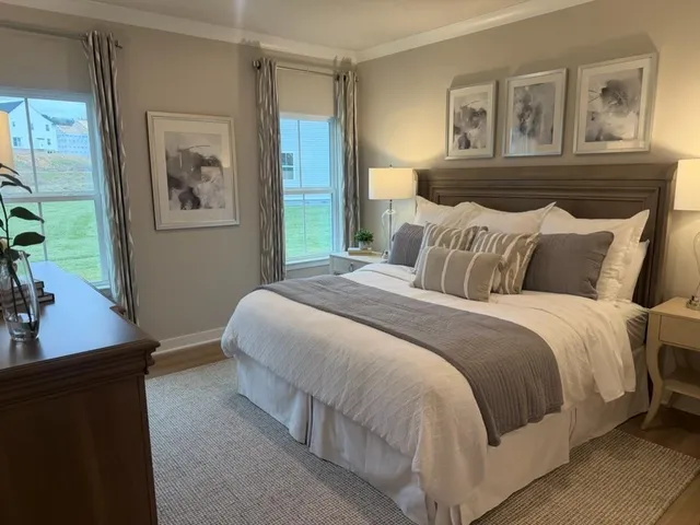 a bedroom with a large bed and a window