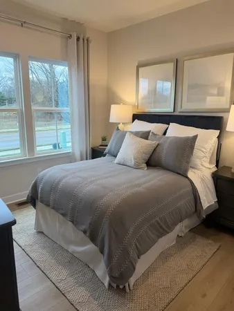 a bedroom with a bed and window