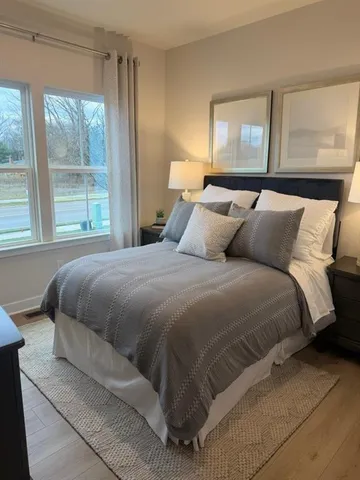 a bedroom with a bed and window