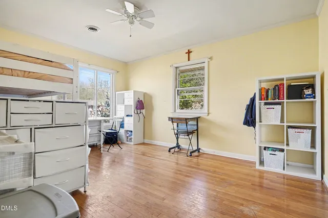 a bedroom with furniture and a wooden floor
