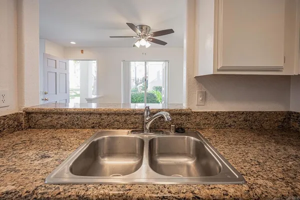 a kitchen with a sink cabinets and window