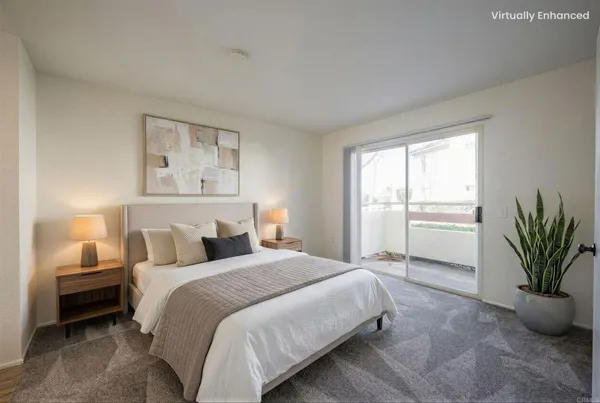 a bedroom with a large bed and a potted plant