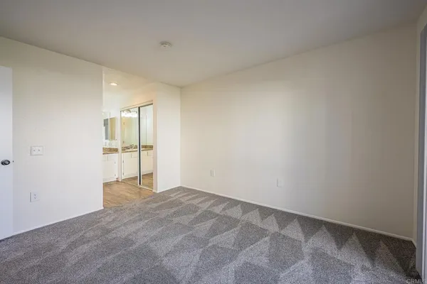 a view of an empty room and a window