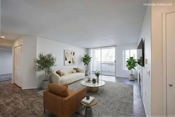 a living room with furniture potted plant and a window