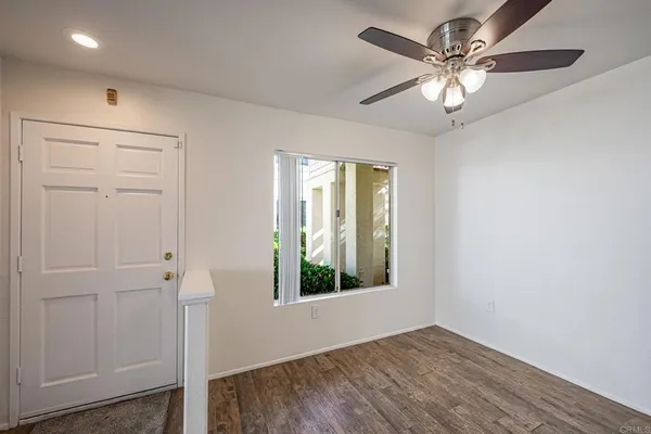 wooden floor in an empty room with a window
