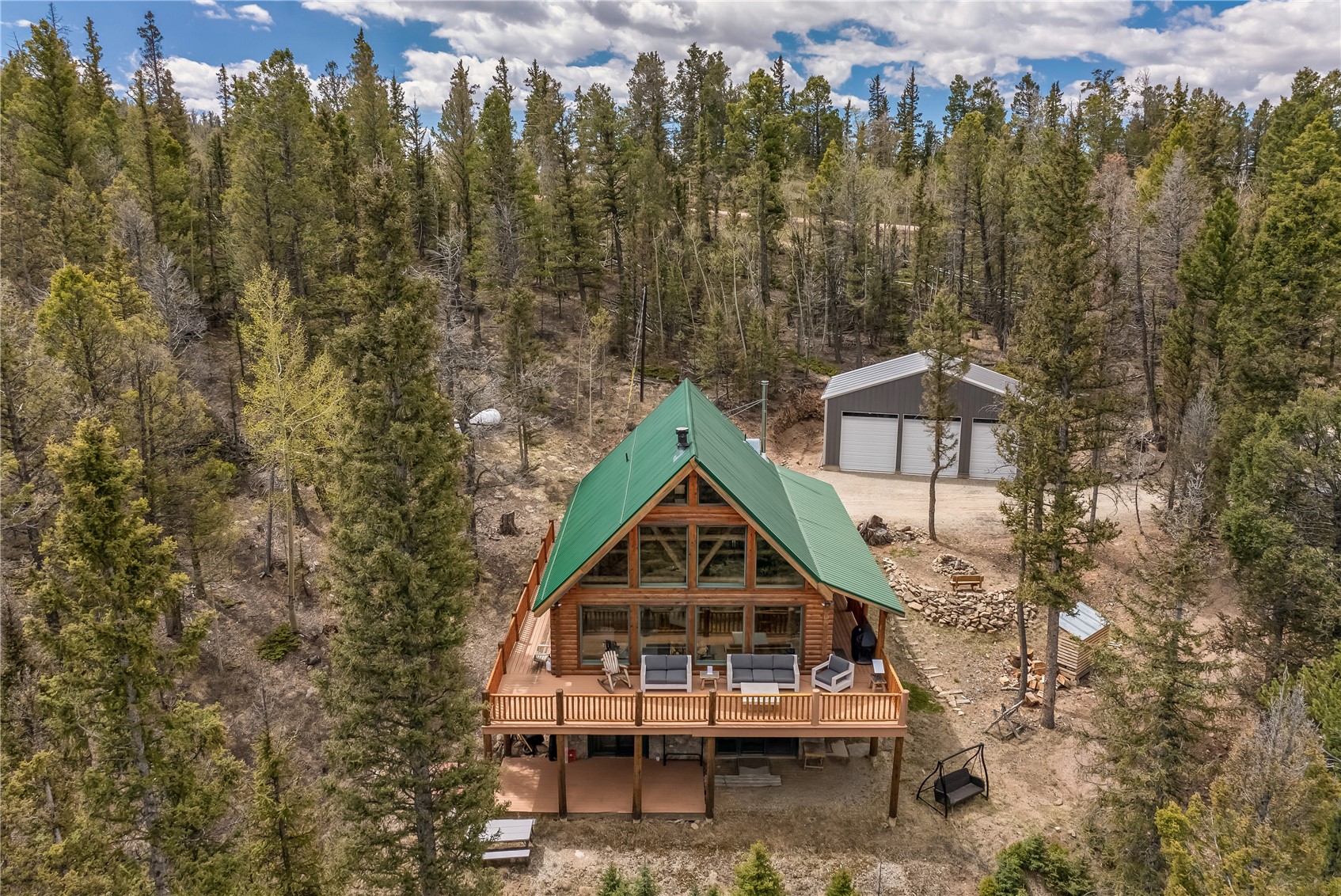 999 Bowstring Como, CO 80456 - Photo 30 of 37 a roof deck with table and chairs under an umbrella