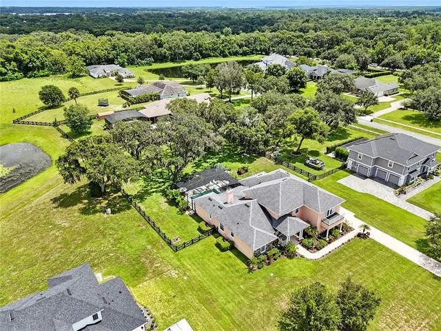 an aerial view of a house with a yard
