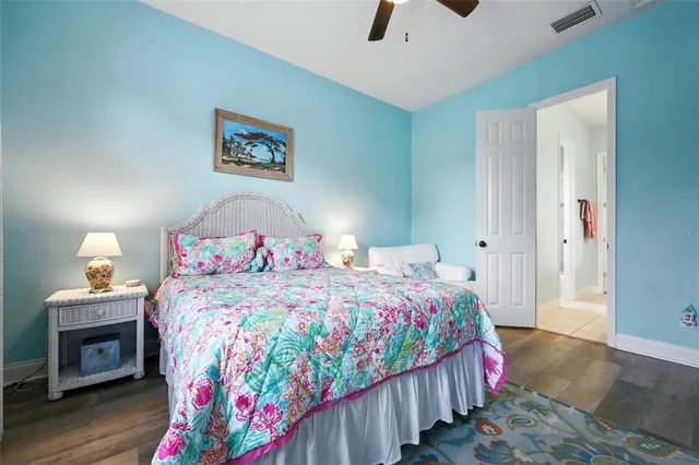 a bathroom with a granite countertop double vanity sink and a mirror