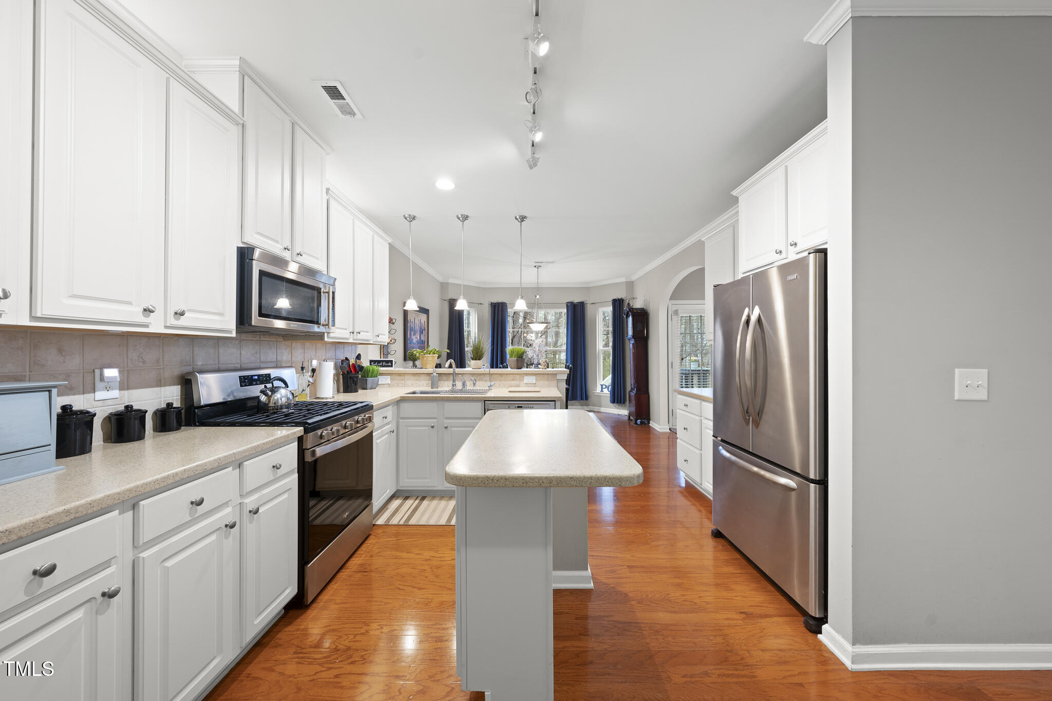 3419 Ranbir Drive Durham, NC 27713 - Photo 10 of 33 a kitchen with stainless steel appliances granite countertop a refrigerator a sink dishwasher a stove and white cabinets with wooden floor
